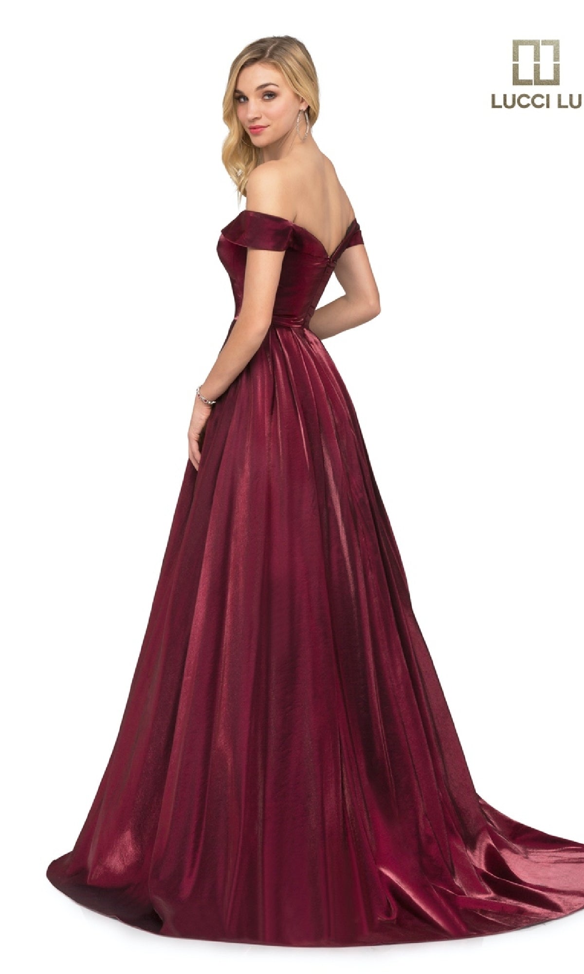 A woman stands, looking over her shoulder in the Lucci Lu 28063 off-the-shoulder, floor-length satin prom dress with a flared skirt. The Lucci Lu logo appears in the top right corner.